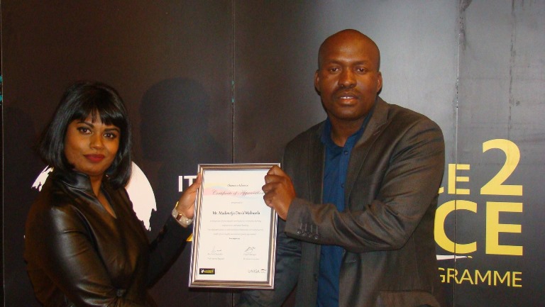 Mr David Mabusela a community learning ambassador receiving a certificate of appreciation from Dr Genevieve James
