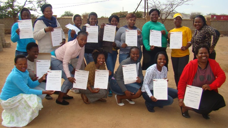 Participants of C2A programme showcasing their certificates
