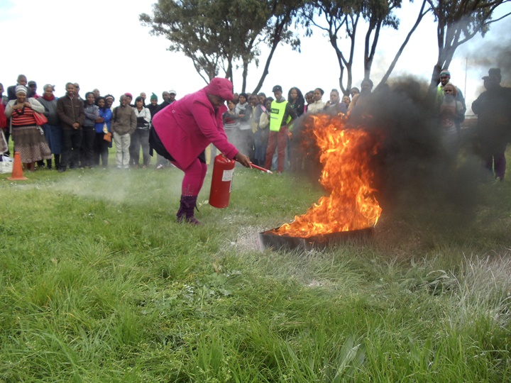 A young woman overcoming her fear of fire in the Community Based Home Fire Safety workshop