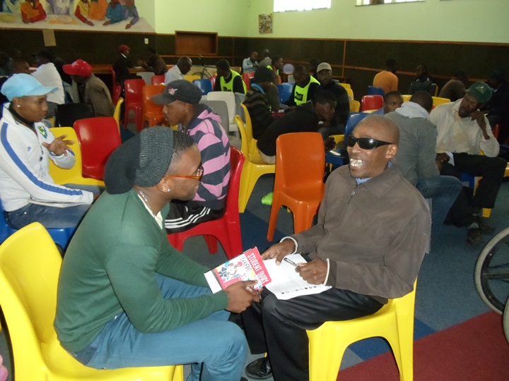 Participants engaging in activities with each other in the Empowering Men in SA workshop