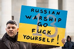Second place: Protester carrying a sign with a slogan at rally in support of Ukraine, outside Ohio Statehouse, in Columbus, Ohio, United States, 26 February 2022. Attribution: Becker1999 / CC-BY-SA 4.0