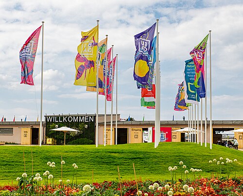Flying flags at the entrance to the Bundesgartenschau 2023 on the former Spinelli military site