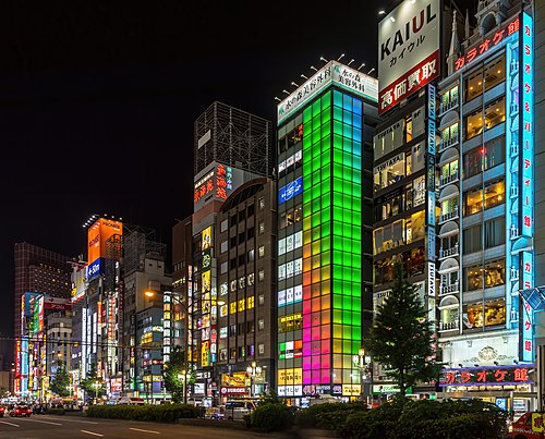 Colorful illuminated facades of buildings at night, with green, blue and pink lights, Kabukicho, Shinjuku, Tokyo