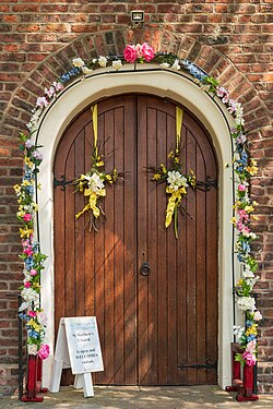 Church door bedecked with flowers