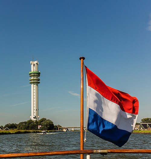 Dutch flag with the Spannenburg tower from the water.