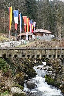 Triberg River Gutach and flags at the entrance to the waterfalls