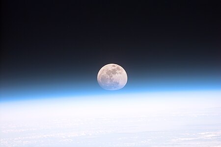 Full moon partially obscured by atmosphere