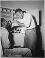 "A dispensary at a Naval ammunition depot in the Marianas. Prevention against a case of sore throat. Patient-Dan Kenne - NARA - 520684.tif