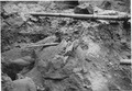 "A 2x6 inch sawed plank imbedded under the river fill gravel over the edge of the bench on the Nevada side of the... - NARA - 293850.tif