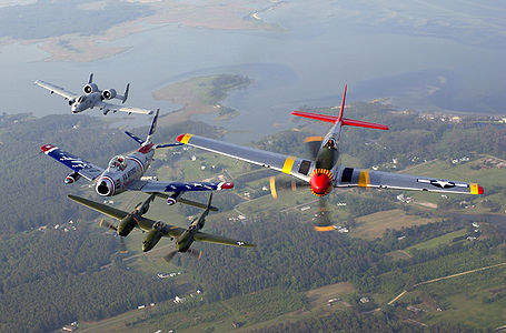 (From left) An A-10 Thunderbolt II, F-86 Sabre, P-38 Lightning and P-51 Mustang fly in a heritage flight formation during an air show at Langley Air Force Base, Va., on May 21. The formation displayed four generations of Air Force fighters.