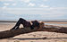 Female reclining on driftwood on the beach.jpg