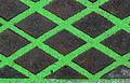 Green sand in grooves of iron drain cover.jpg