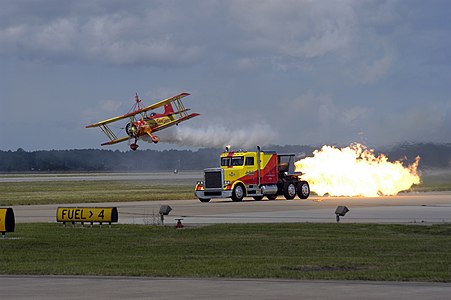 Naval Air Station Oceana, Va. (Sept. 25, 2004) - Kent Shockley and his jet truck “ShockWave,” race Gene Soucy’s “Showcat” biplane at the 2004 "In Pursuit of Liberty," Naval Air Station Oceana Air Show. ShockWave is powered by three afterburning jet engines that can produce 36,000 horsepower. The air show, held Sept. 24-26, showcased civilian and military aircraft from the Nation's armed forces, which provided numerous flight demonstrations and static displays. U.S. Navy photo by Photographer's Mate 2nd Class Daniel J. McLain (RELEASED)
