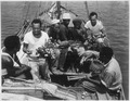 "34th CB's trading with natives from Malaita. Left to right, native, Percy J. Hope, MS2c, Lilton T. Walker, S1c, two nat - NARA - 520630.tif