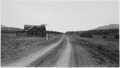 "Abandoned general store and other log buildings" - NARA - 292843.tif