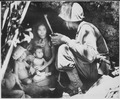 "A member of a Marine patrol on Saipan found this family of Japs hiding in a hillside cave. The mother, four children an - NARA - 532380.tif